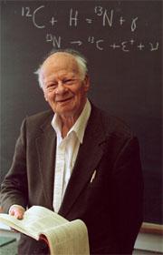 Hans Bethe in 1996, in front of his famous carbon-oxygen-nitrogen cycle equation.
