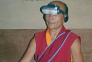 A monk dons goggles for an optical illusion test.  Click here to take a test yourself.