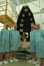 Students stand proud by their satellite.