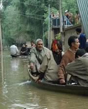 Residents leave a flooded neighborhood in Srinagar, India, this September.