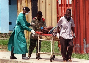 Patient with Ebola being wheeled out on stretcher