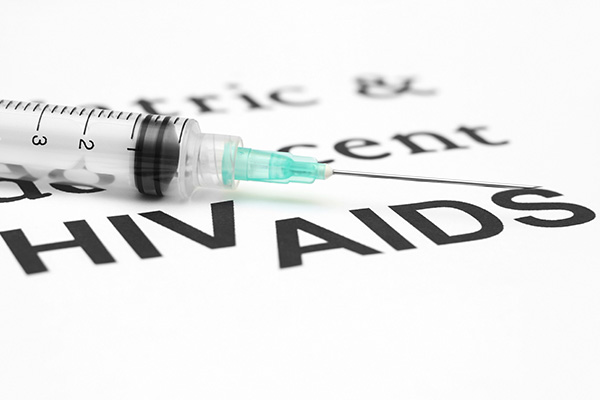 Syringe above the words HIV and AIDS