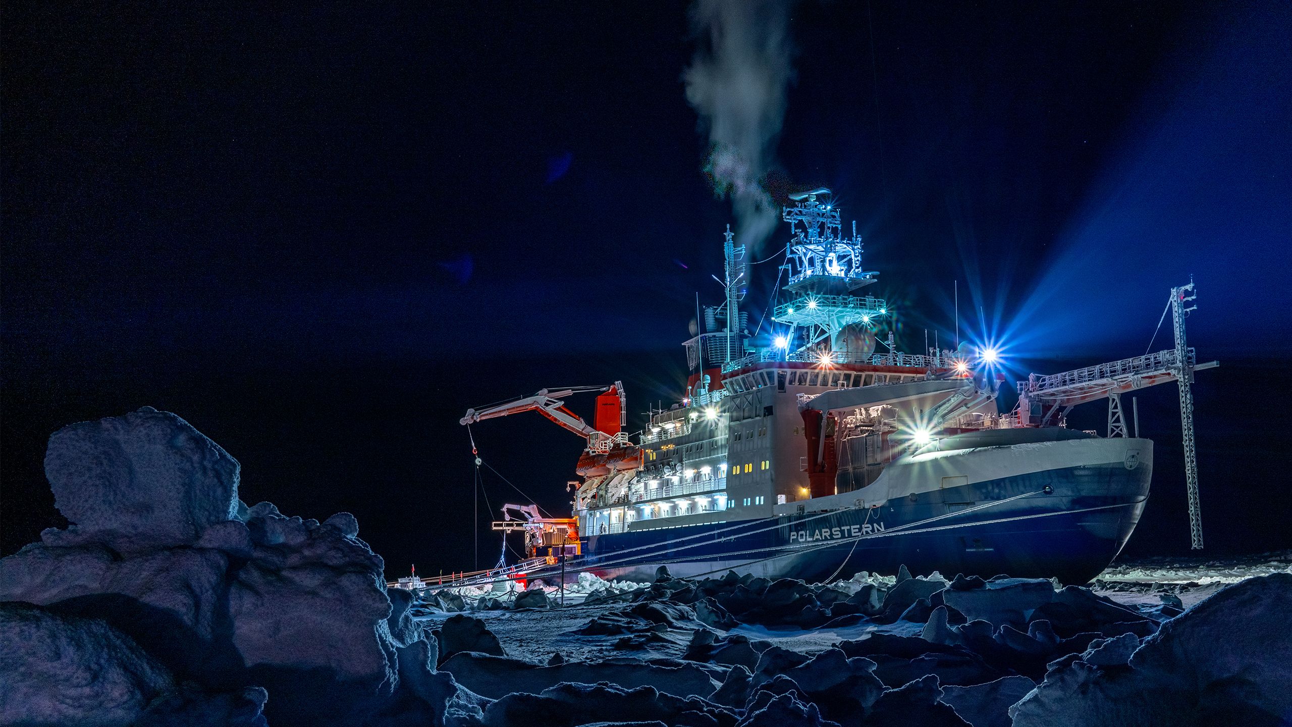The Polarstern research vessel photographed in darkness while trapped in ice over the Arctic winter