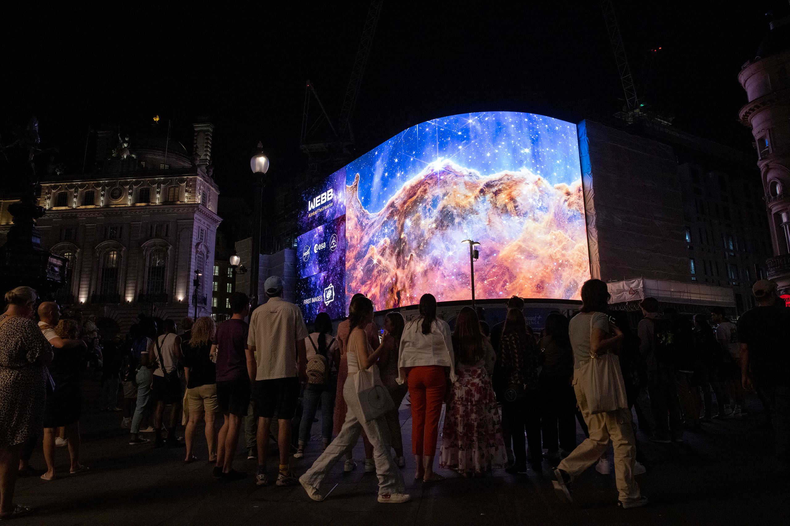 A general view of the broadcast of NASA's first images from James Webb Space Telescope to screens in Picadilly Circus