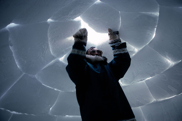 Inuit building an igloo