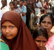Survivors wait for food in a camp in Kalkudah, Sri Lanka.